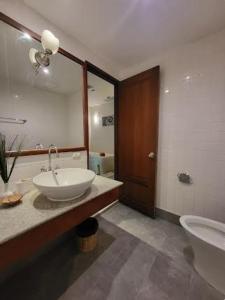 a bathroom with a sink and a toilet and a mirror at Heavenly place in Surin Beach