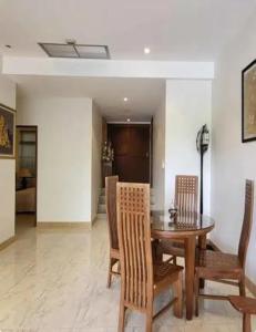 a dining room with a wooden table and chairs at Heavenly place in Surin Beach