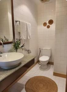 a white bathroom with a sink and a toilet at Heavenly place in Surin Beach +9 photos
