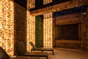 a room with two chairs and a stage with lights at Góralski Resort Family & SPA in Białka Tatrzańska