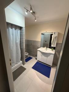 a bathroom with a sink and a mirror at Sobe i apartmani Lipa 12 in Repušnica