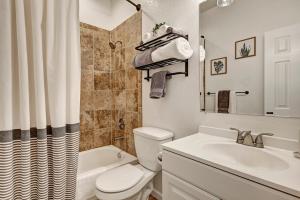 a bathroom with a toilet and a sink and a tub at Historic Downtown Trails & Park in Colorado Springs