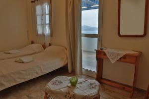 A bed or beds in a room at Stelios Rooms