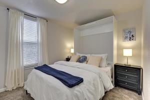 a bedroom with a large bed with a blue blanket on it at Historic Downtown Trails & Park in Colorado Springs