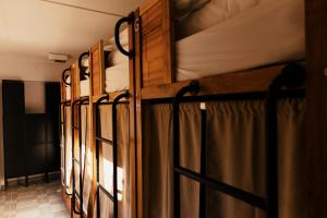 a row of bunk beds in a room at Lisbon Surf Hostel in Carcavelos