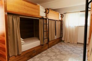 two bunk beds in a room with a window at Lisbon Surf Hostel in Carcavelos