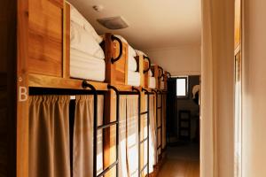 a row of bunk beds in a room at Lisbon Surf Hostel in Carcavelos
