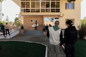 a group of people standing outside of a house at Lisbon Surf Hostel in Carcavelos