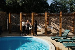 a group of people standing next to a swimming pool at Lisbon Surf Hostel in Carcavelos