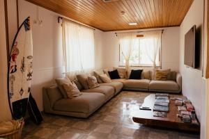 a living room with a couch and a table at Lisbon Surf Hostel in Carcavelos