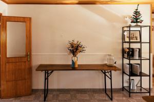a table with a vase on it in a room at Lisbon Surf Hostel in Carcavelos