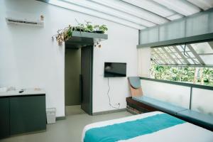 a bedroom with a bed and a sink and a window at Malhar - Your Home Beneath The Clouds in Sultan Bathery +29 photos