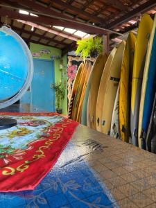 a row of surfboards lined up in a room at Hostel Surf de Bem in Florianópolis