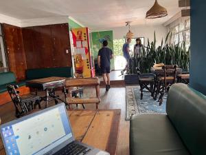 a living room with a laptop computer on a table at Hostal Cultural Casa Morobik in Popayan