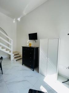 a white room with a dresser and a mirror at Casa Vacanza Margherita B&B in Acerra