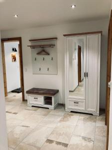 a room with a mirror and a cabinet and a counter at Ilgerhof Ferienwohnungen in Oberaudorf