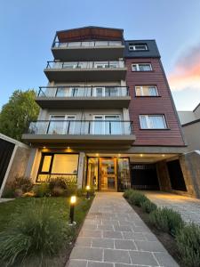 圣卡洛斯-德巴里洛切Portales de la Patagonia Apartments的前面有一条小路的高楼