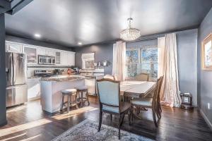 a kitchen with a table and a dining room at Scenic Gem: Waterfront View, Beach Access in Wading River