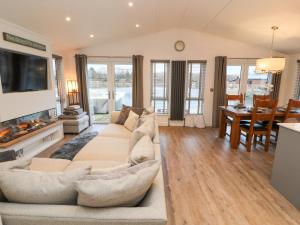 a living room with a couch and a dining room at 12A Lake Escape in Carnforth