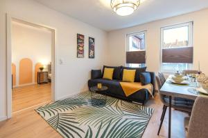 a living room with a couch and a table at Apartment - Terrasse - Modern - Küche in Gotha