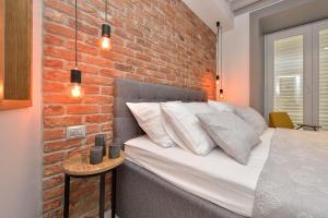 a bedroom with a large bed and a large window at Apartments & Rooms Mareta Exclusive in Zadar