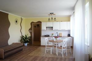 a kitchen and dining room with a table and chairs at Agroturystyka Marianówek in Dobrocin