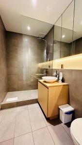 a bathroom with a sink and a shower at Studio Fischer à la Pétrusse 001 in Luxembourg