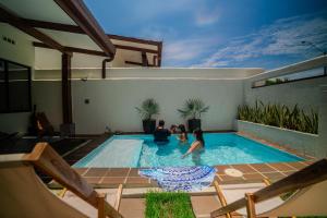 two children playing in a swimming pool in a house at Pedasí 2-Bedroom Oasis with Pool in Purio