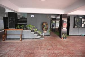 a lobby with stairs and potted plants in a building at Castle Inn Oasis Homestay in Dehradun
