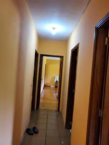 a hallway of a room with two doors and shoes at Casa de Campo Mairinque in Mairinque