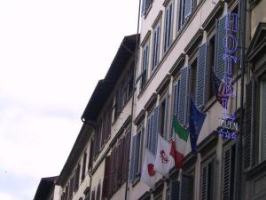 a building with flags on the side of it at BYPILLOW Goldoni in Florence