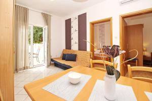 a living room with a table and a couch at Apartments Limun Zarok in Baška