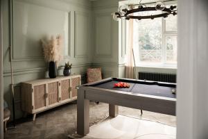 a room with a pool table and a window at Luxurious Manor House with Sea Views - Sleeps 10 in Amlwch
