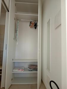 a walk in closet with white walls and a door at Casa Cristina in Ventimiglia