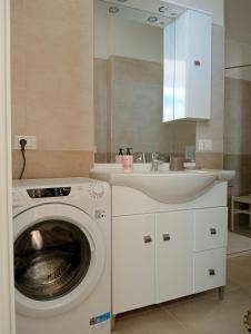 a bathroom with a washing machine and a sink at Casa Cristina in Ventimiglia