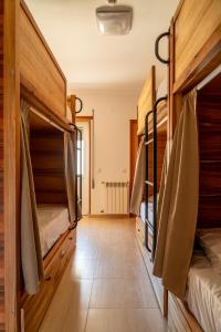 a room with bunk beds in a house at Lisbon Surf Hostel in Carcavelos