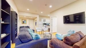 a living room with two couches and a tv at Newly Renovated 2-bed, Back Bay Near Mgh, Bu, Mit in Boston