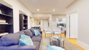 a living room with a couch and a table at Newly Renovated 2-bed, Back Bay Near Mgh, Bu, Mit in Boston