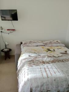 a bedroom with a bed and a tv on a wall at Casa Cristina in Ventimiglia