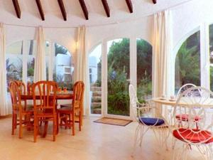 a dining room with a table and chairs at Holiday Home Sibila in Jávea