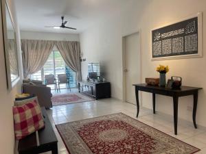 a living room with a couch and a table at Inap Kasturi D'Gambang in Gambang