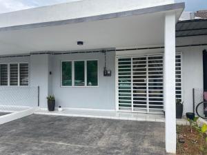a white house with a patio and a window at Inap Kasturi D'Gambang in Gambang
