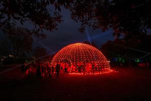 a large red light orb with people standing around it at night at 5 Star Homes- Free Wifi & Parking, Contractor & family friendly in Pallion