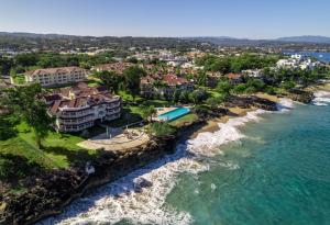 an aerial view of a resort next to the ocean at Hispaniola Beach Condo 9a2oceanviewbeachpool in Sosúa