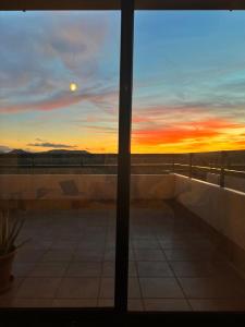 a view of the sunset from a window at Casa Solayla Origomare in Lajares