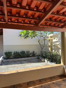 a view of a patio under a roof with plants at Casa Aconchego Itaici in Caldas Novas +17 photos