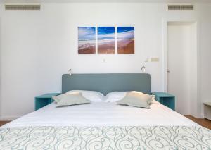 a bedroom with a large white bed with two pillows at Dubrovnik Luxury Residence – L’Orangerie in Dubrovnik