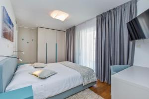 a bedroom with a bed and a large window at Dubrovnik Luxury Residence – L’Orangerie in Dubrovnik