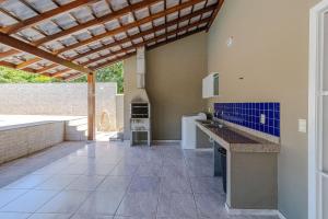 a kitchen with a counter and a wooden ceiling at Casa com piscina e churrasqueira na Praia Seca in Araruama