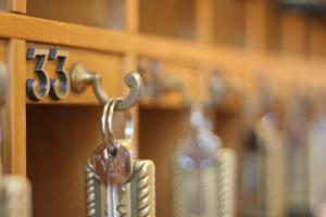 a metal key hanging from a book shelf at Hotel Kent in Rome